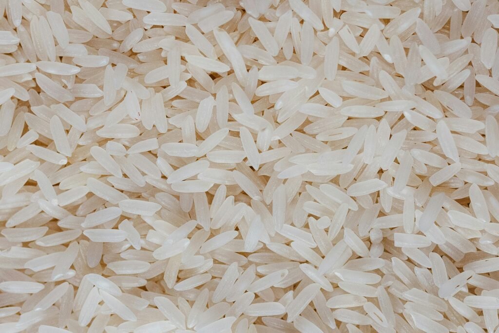 Detailed view of uncooked white rice grains, showcasing texture and pattern.